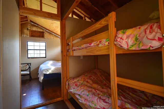 a view of a hallway with wooden floor and furniture