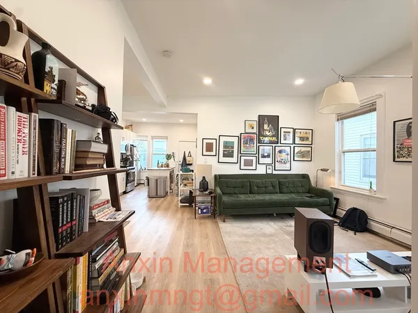 a living room with furniture and a book shelf