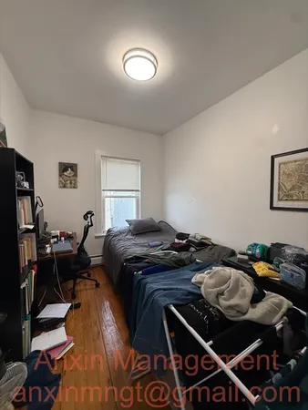 a bedroom with furniture and a window