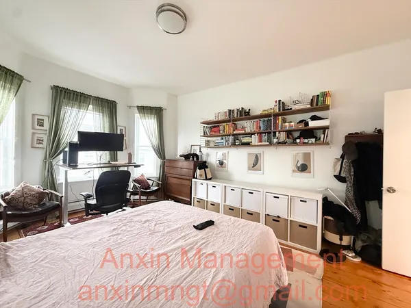 a bedroom with a bed and a large mirror