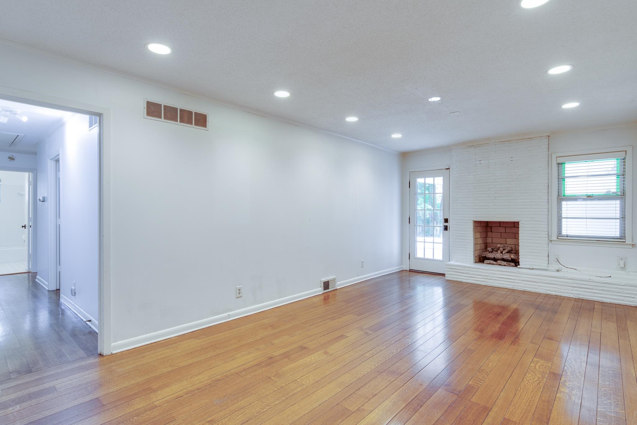 2021 Sunset Road Germantown, TN 38138 - Photo 12 of 26 Unfurnished living room featuring visible vents, recessed lighting, light wood-style floors, and baseboards