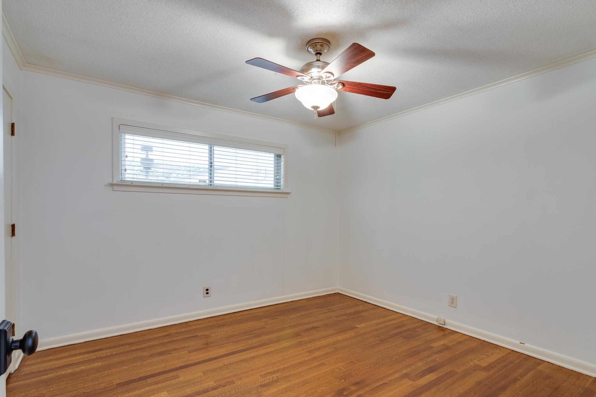 2021 Sunset Road Germantown, TN 38138 - Photo 14 of 26 Empty room featuring crown molding, baseboards, ceiling fan, and wood finished floors