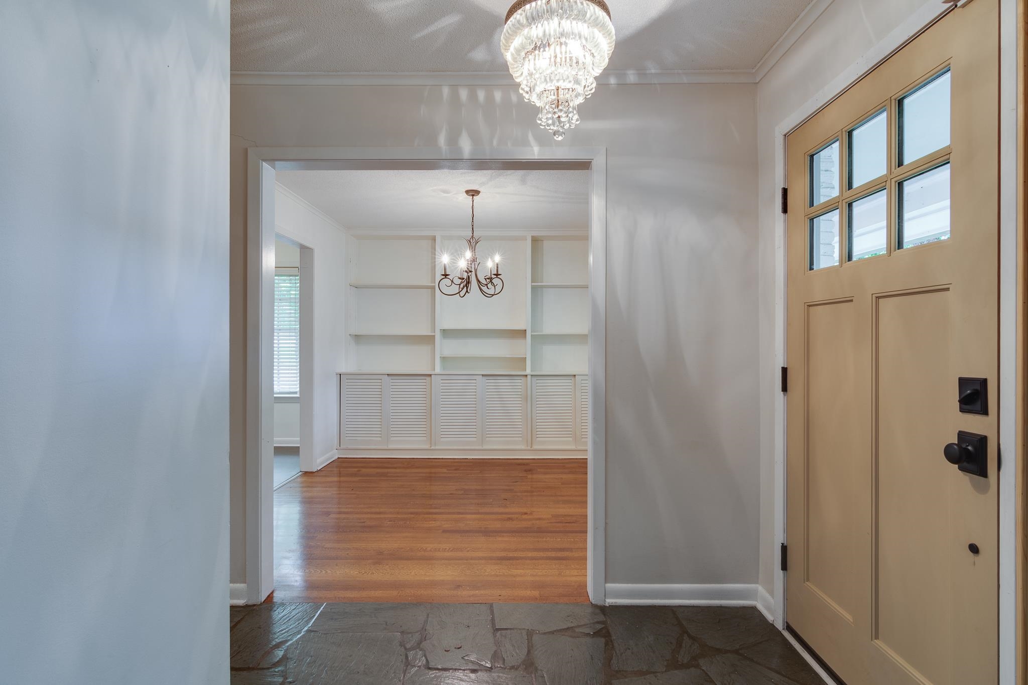 2021 Sunset Road Germantown, TN 38138 - Photo 2 of 26 Foyer featuring crown molding, baseboards, wood finished floors, and a notable chandelier