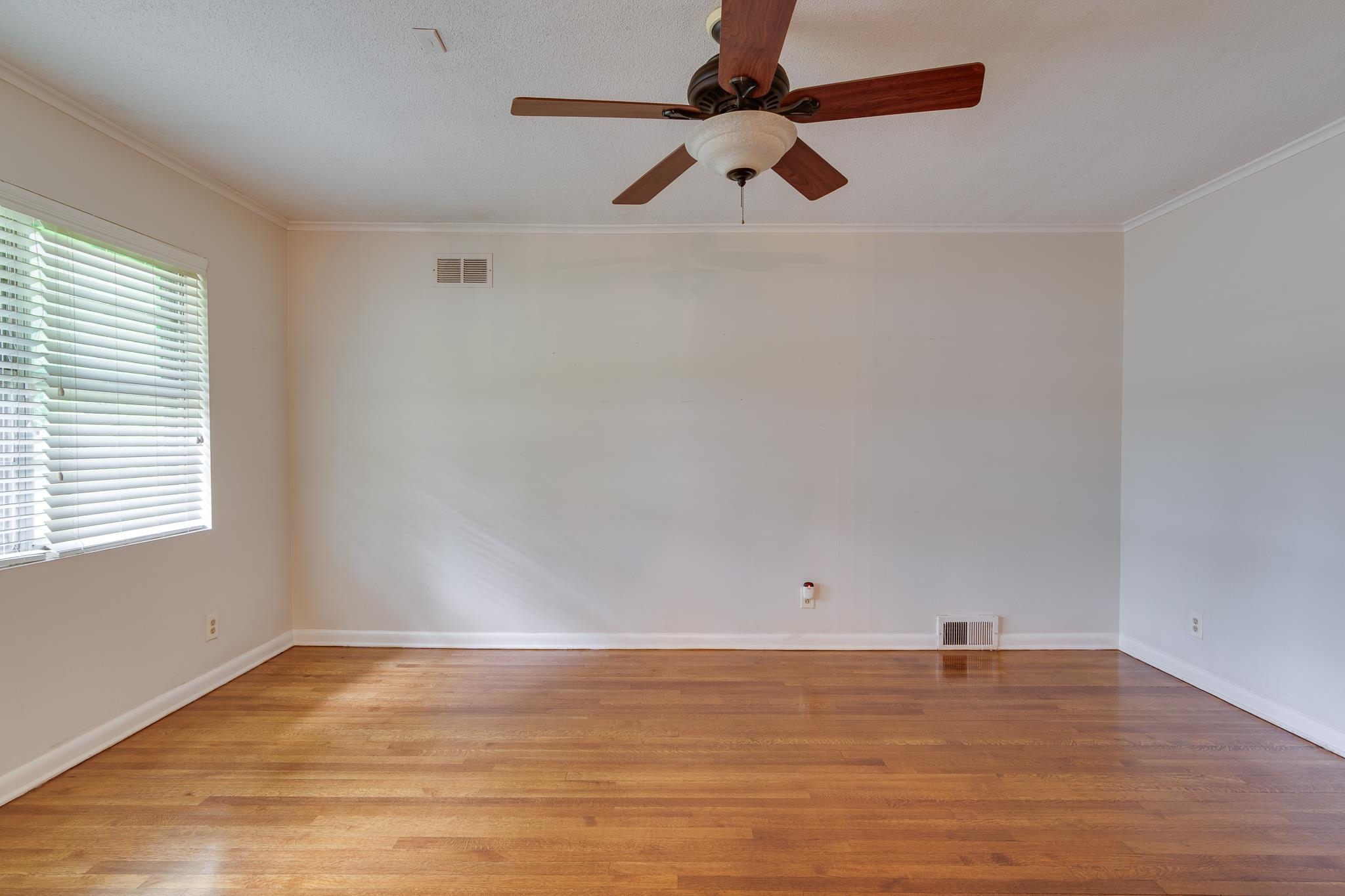 2021 Sunset Road Germantown, TN 38138 - Photo 3 of 26 Spare room with visible vents, ornamental molding, and light wood-type flooring
