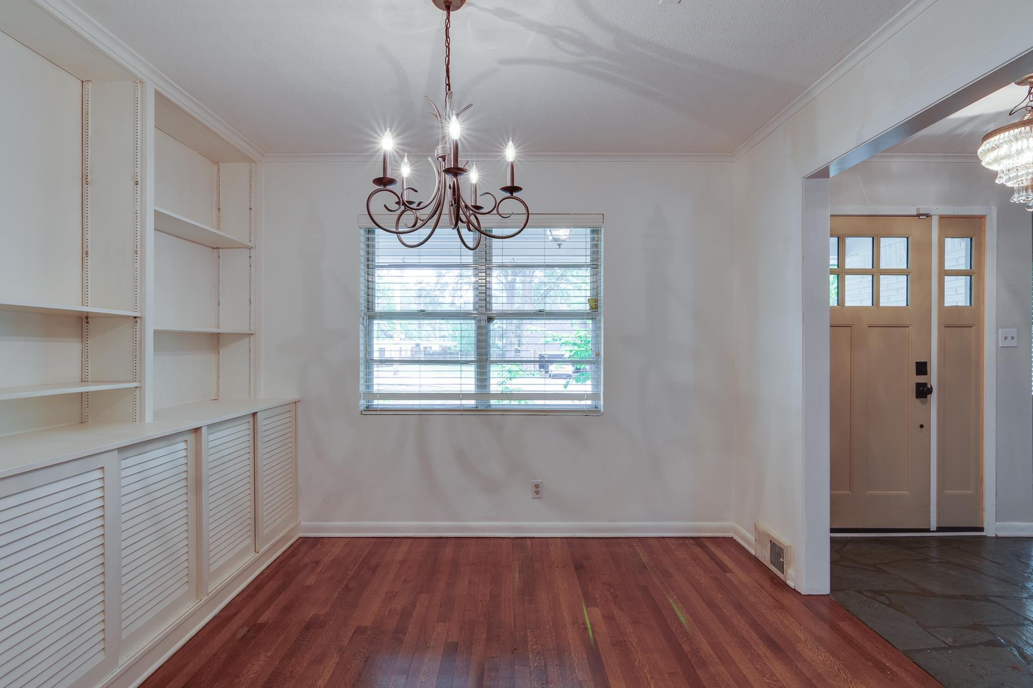 2021 Sunset Road Germantown, TN 38138 - Photo 4 of 26 Unfurnished dining area with crown molding, an inviting chandelier, a healthy amount of sunlight, and visible vents