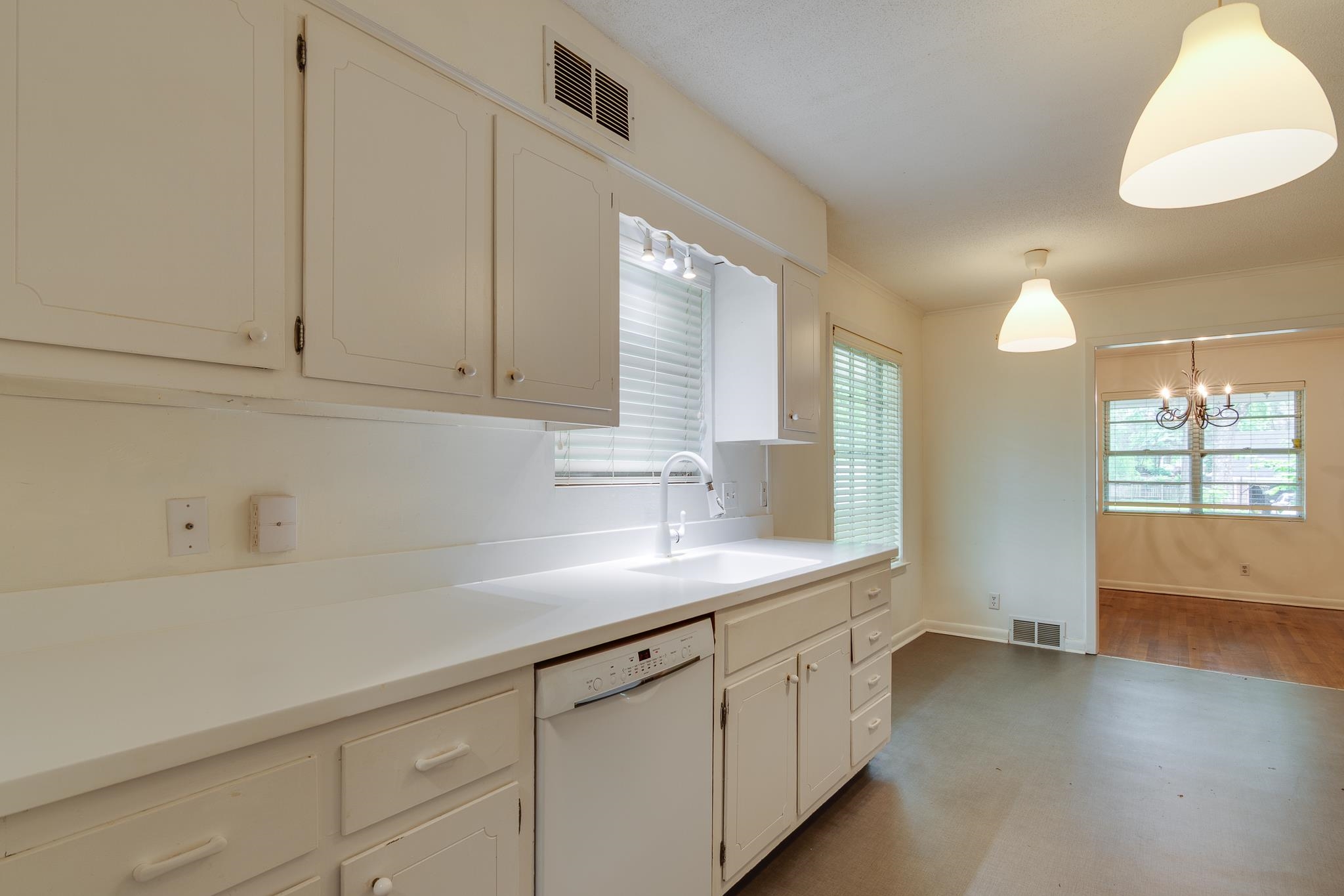 2021 Sunset Road Germantown, TN 38138 - Photo 9 of 26 Kitchen with white dishwasher, a chandelier, a sink, and visible vents