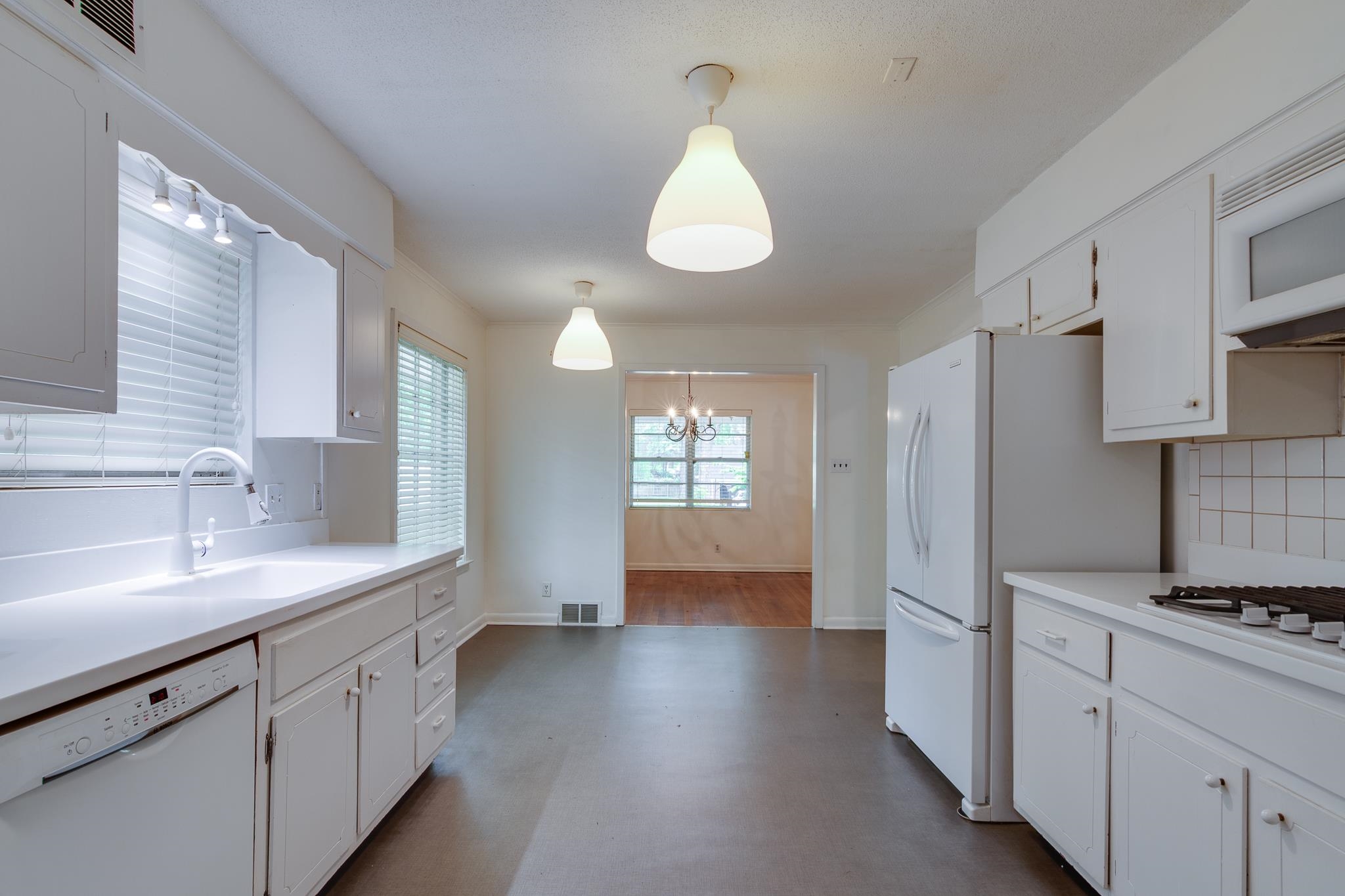 2021 Sunset Road Germantown, TN 38138 - Photo 10 of 26 Kitchen featuring white cabinets, a sink, white appliances, light countertops, and a chandelier