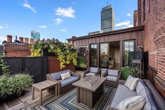 a view of a terrace with couches and potted plants