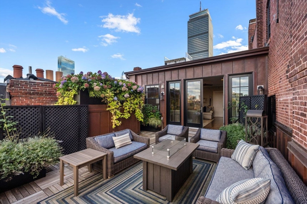 a view of a terrace with couches and potted plants
