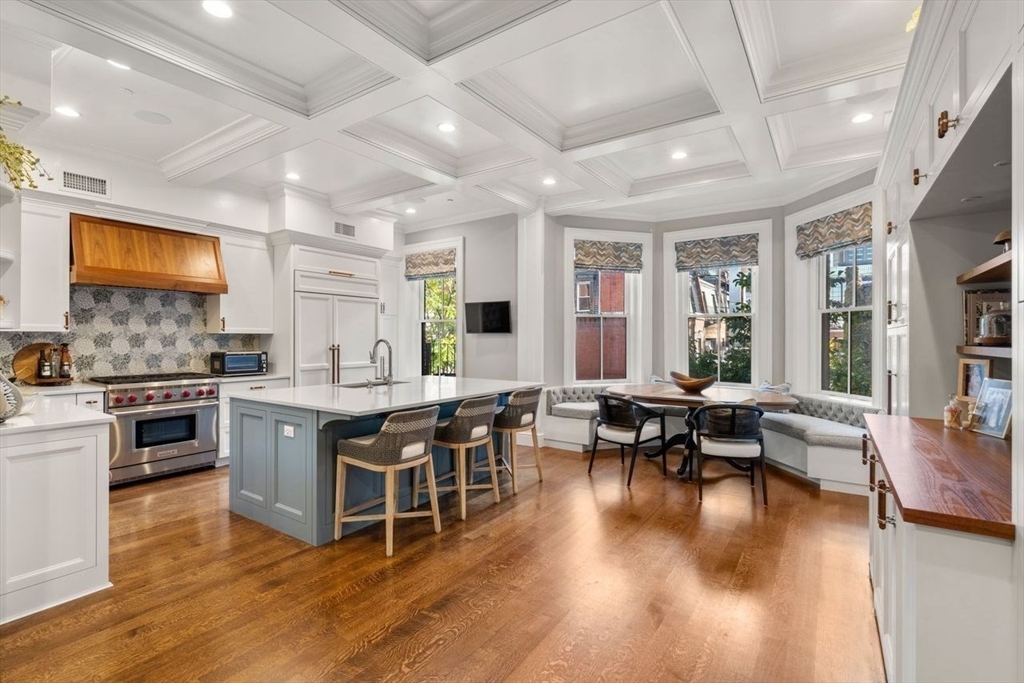 288 Commonwealth Avenue, Unit 3 Boston, MA 02115 - Photo 11 of 25 a kitchen with stainless steel appliances granite countertop wooden floors and view living room
