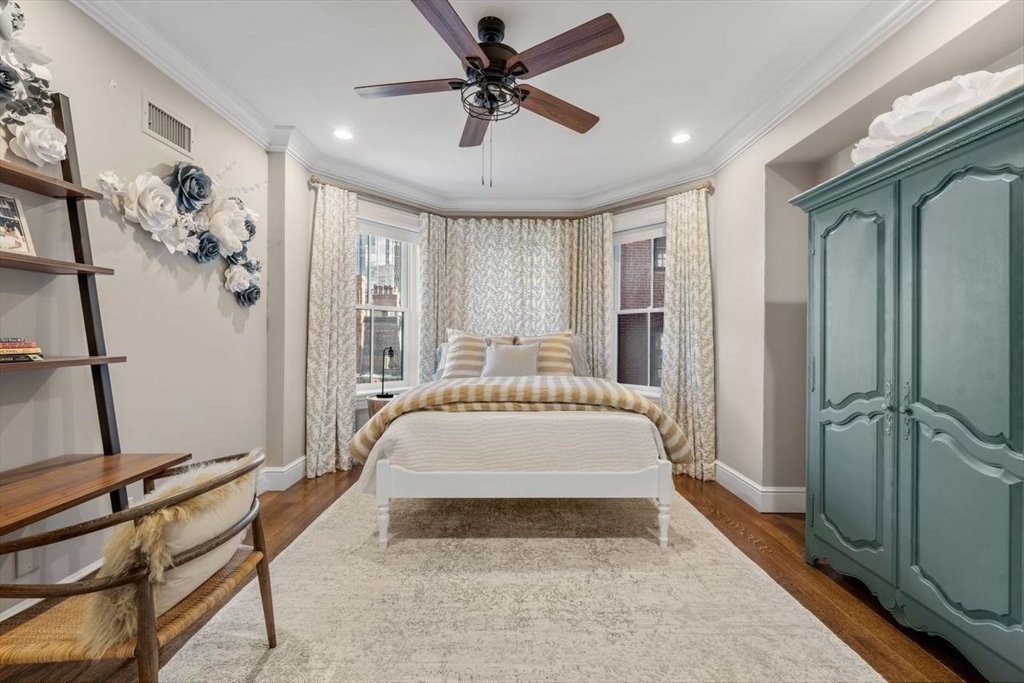 288 Commonwealth Avenue, Unit 3 Boston, MA 02115 - Photo 18 of 25 a spacious bedroom with a large bed and a chandelier