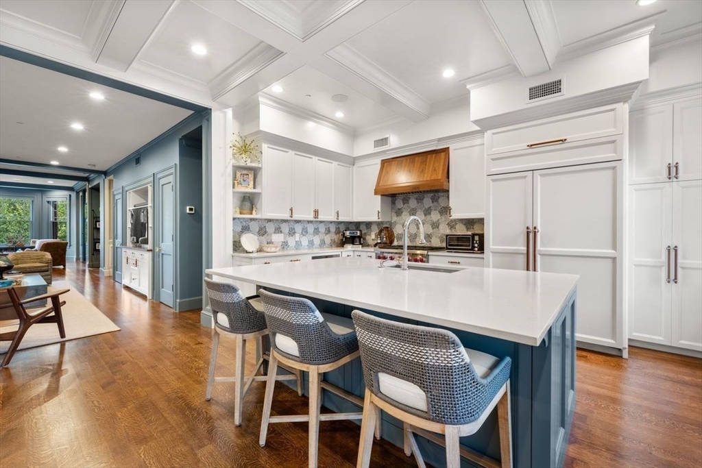 288 Commonwealth Avenue, Unit 3 Boston, MA 02115 - Photo 10 of 25 a kitchen with stainless steel appliances granite countertop a table chairs refrigerator and sink