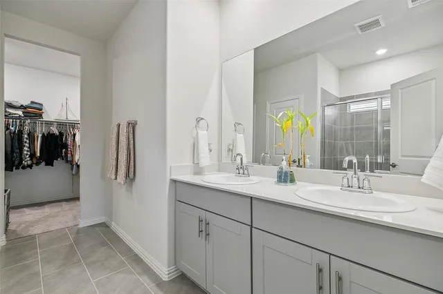 a bathroom with a double vanity sink and a mirror