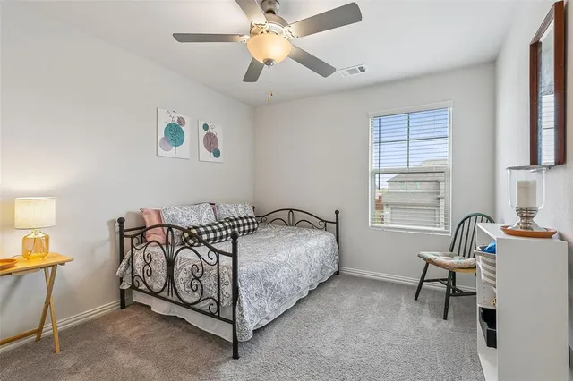 a bedroom with a bed and a chair