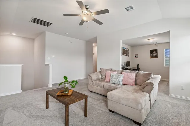 a living room with furniture and a potted plant