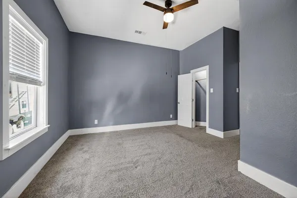 an empty room with windows and closet