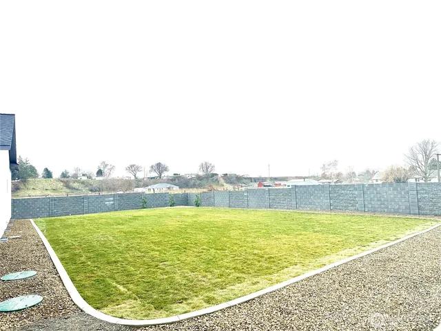 a kitchen with stainless steel appliances kitchen island granite countertop a sink a stove and a wooden floors