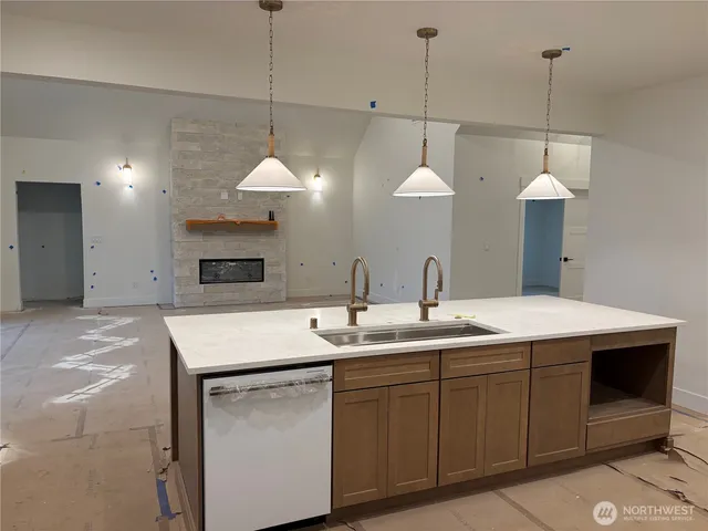 a view of a hallway with wooden floor and a ceiling fan