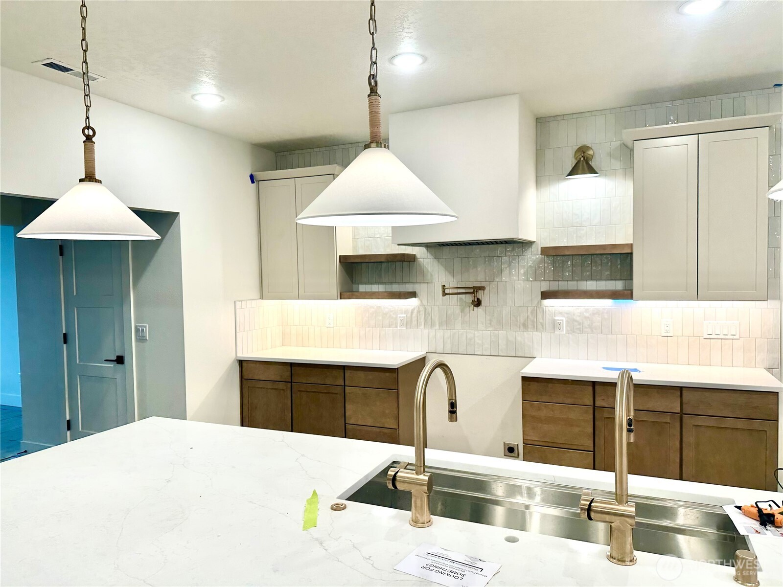 511 Southwest 12th Street College Place, WA 99324 - Photo 9 of 31 a kitchen with stainless steel appliances kitchen island granite countertop a sink a stove and a wooden floors