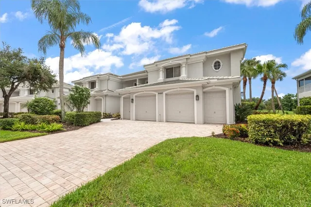 a front view of a house with a garden and plants