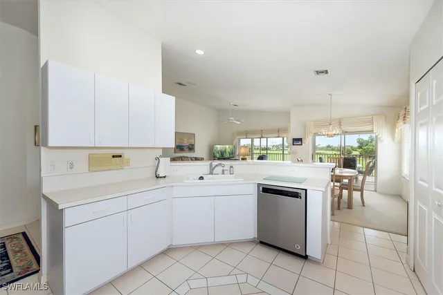 a kitchen with a sink cabinets and appliances