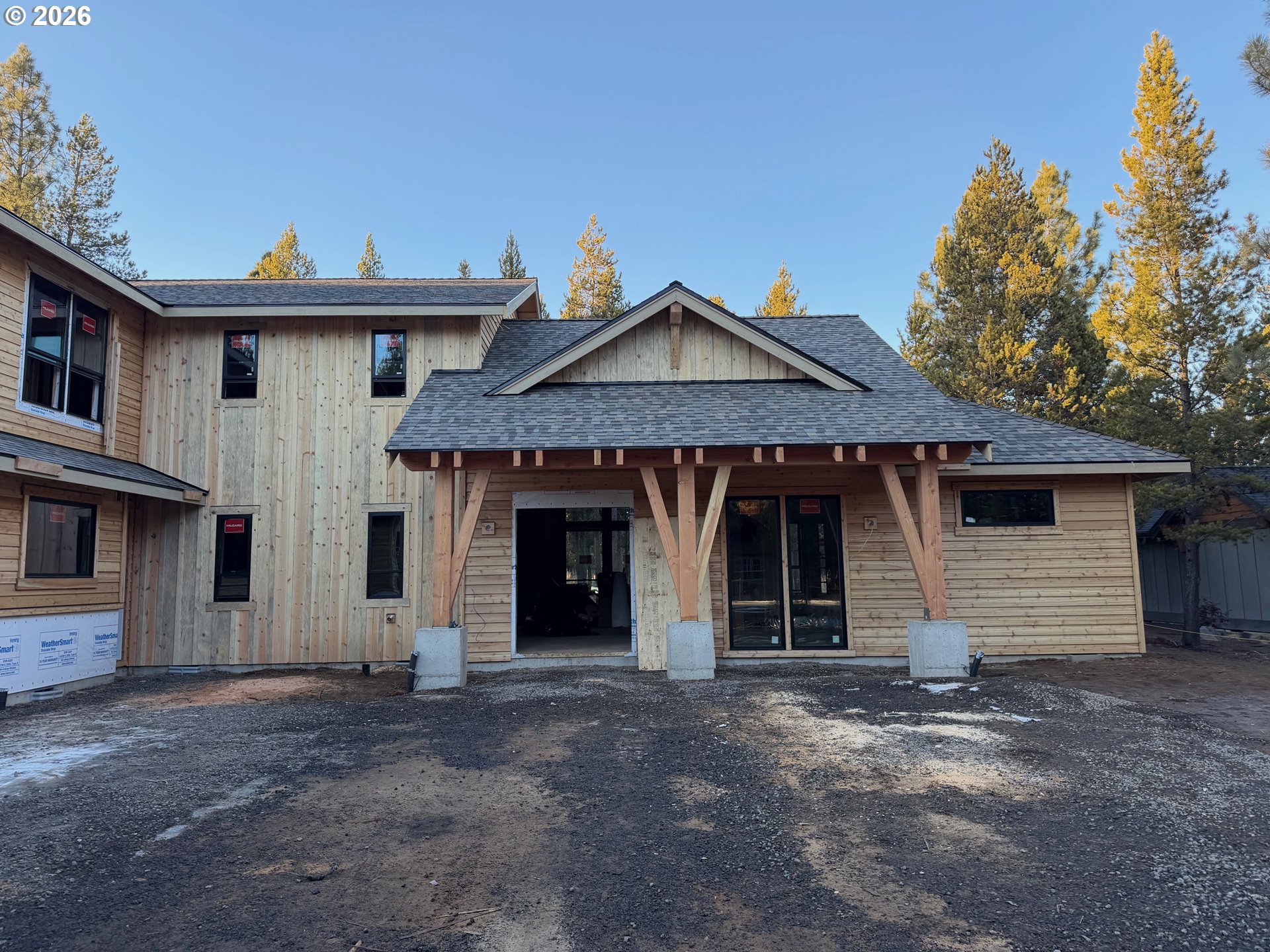 56322 Fireglass Loop Bend, OR 97707 - Photo 2 of 5 a front view of a house with a yard and garage