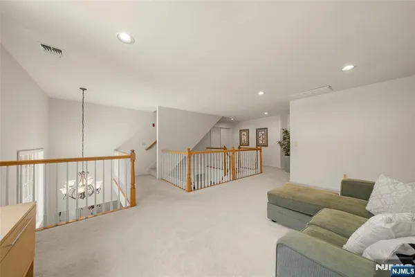 a living room with furniture and stairs