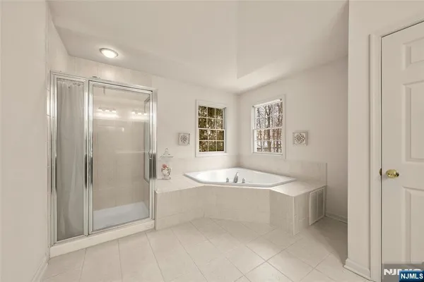 a spacious bathroom with a sink a mirror and a bathtub
