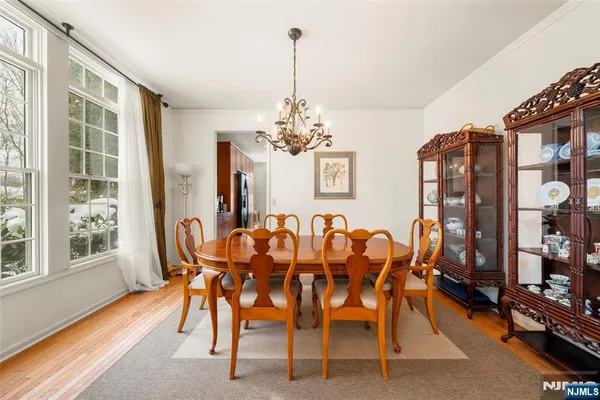 a dining room with furniture a chandelier and window