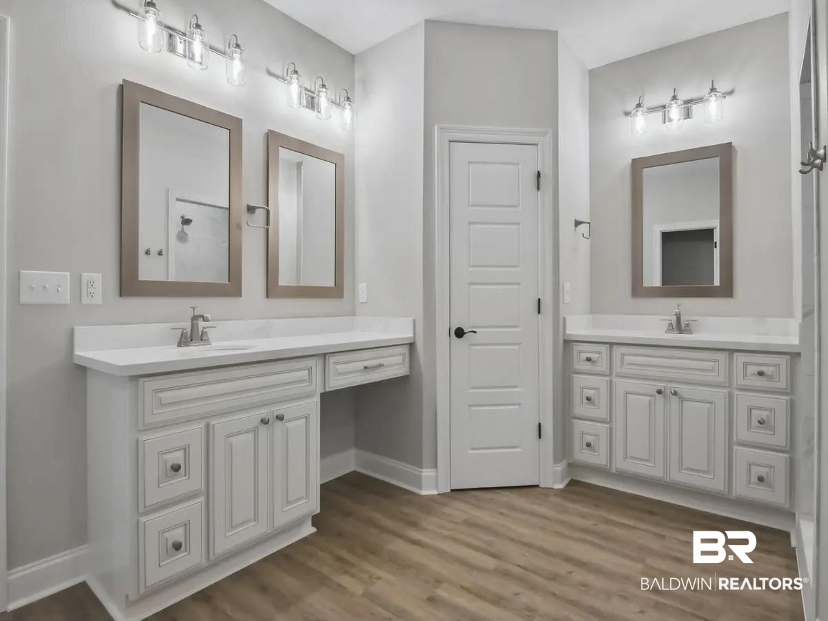 10174 Grady Lane Mobile, AL 36695 - Photo 8 of 14 Full bathroom with two vanities and light wood-type flooring