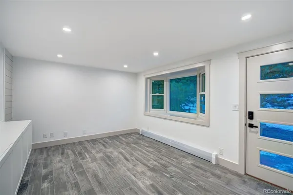wooden floor in an empty room with a window