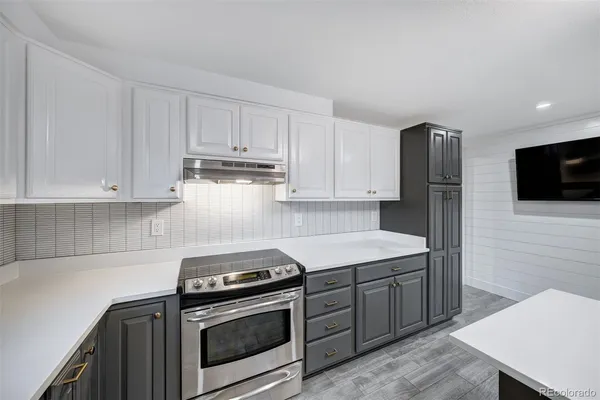 a kitchen with stainless steel appliances granite countertop a stove a refrigerator and a microwave
