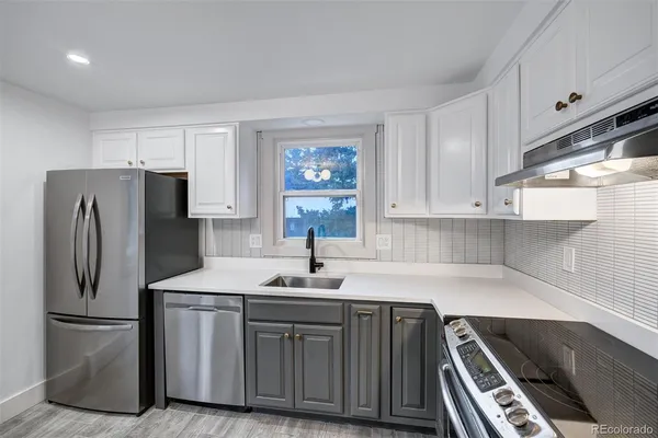 a kitchen with refrigerator and cabinets