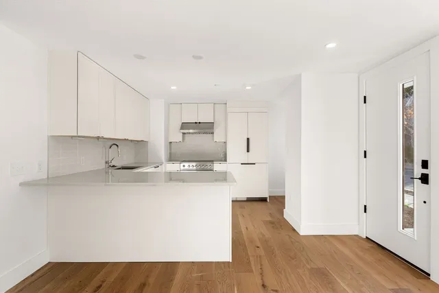 a kitchen with stainless steel appliances a sink and a refrigerator