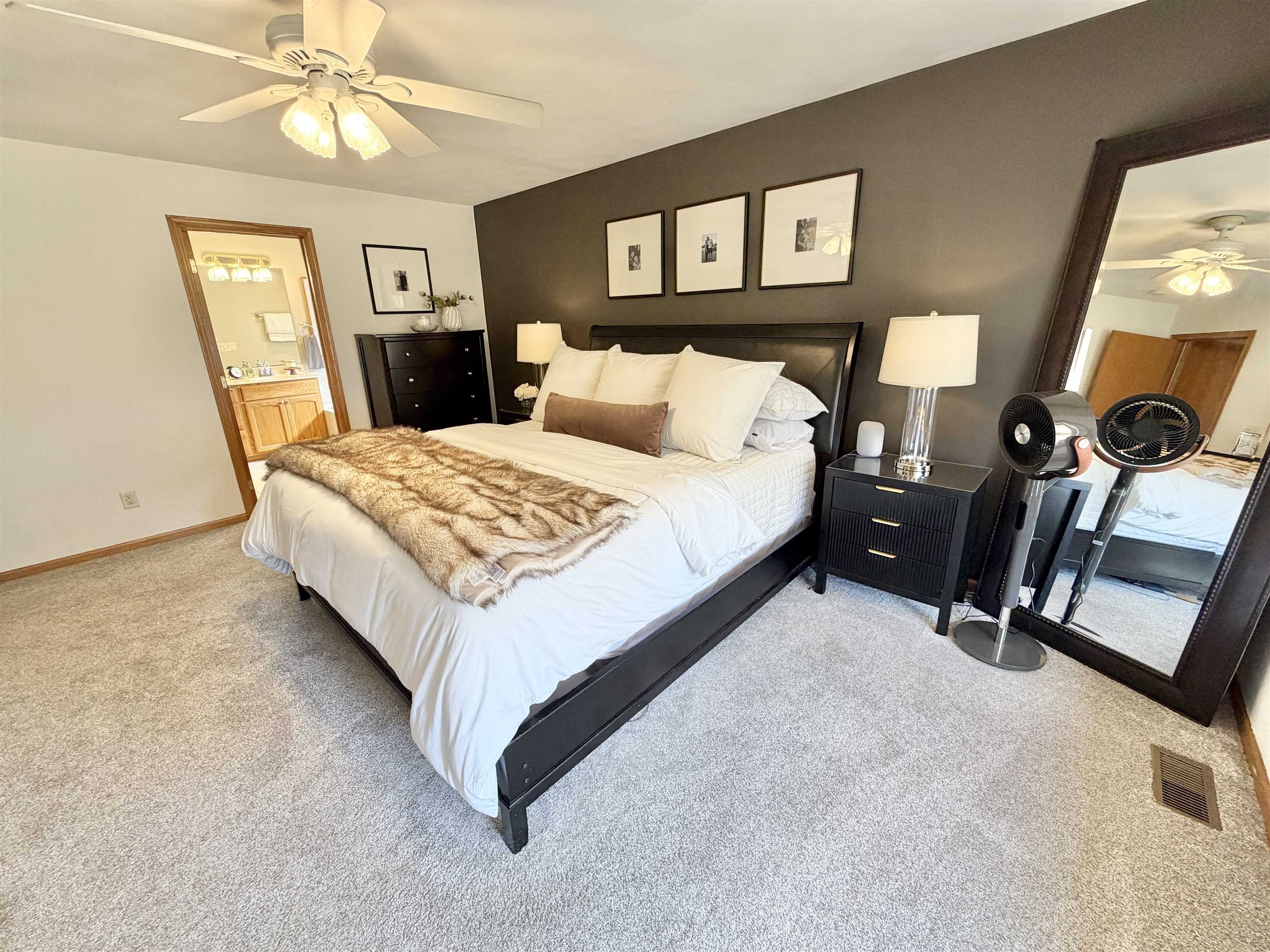 9102 River View Trail Roscoe, IL 61073 - Photo 17 of 40 a bed room with a bed and a chandelier