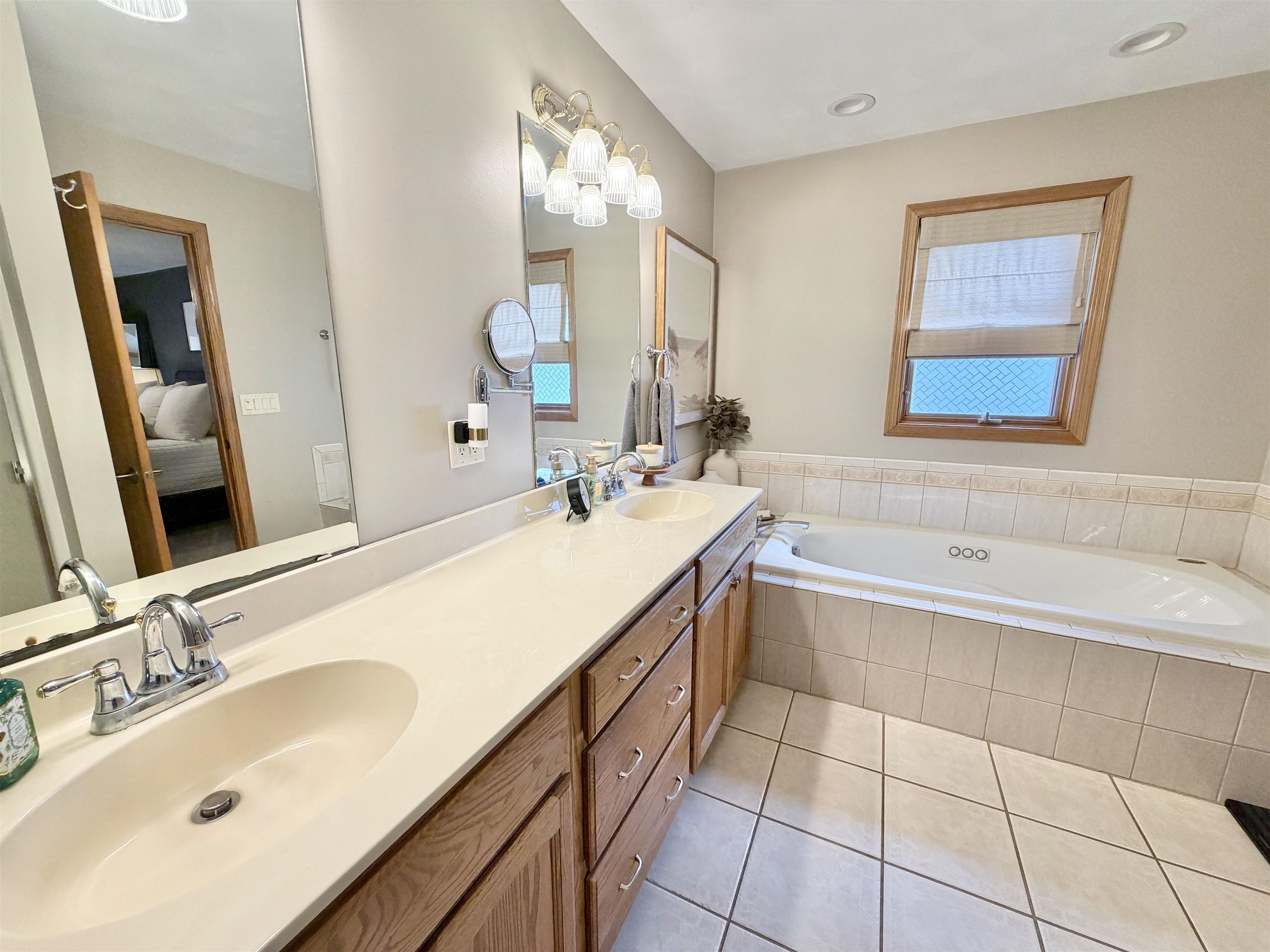 9102 River View Trail Roscoe, IL 61073 - Photo 19 of 40 a bathroom with a tub sink and mirror
