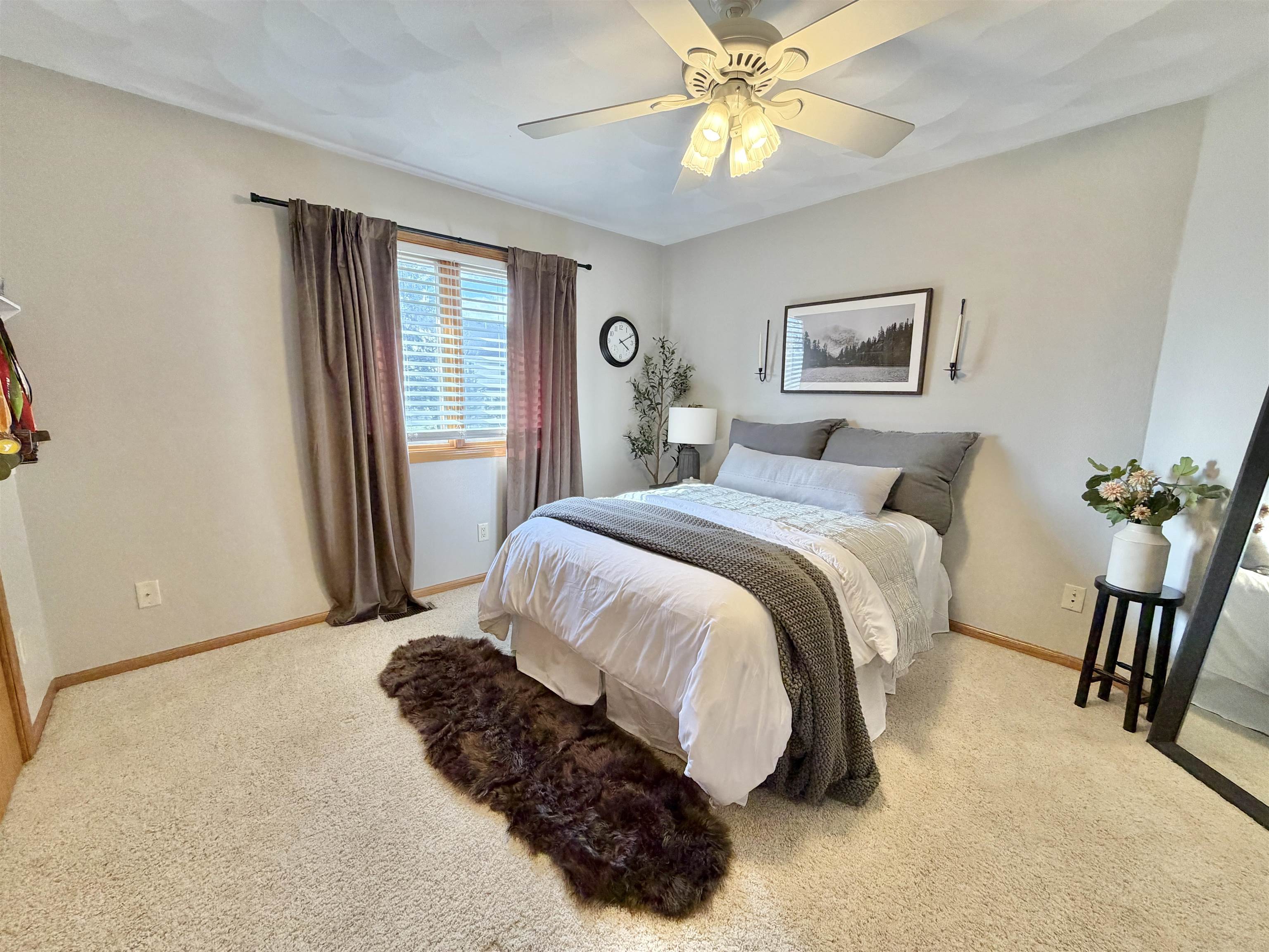 9102 River View Trail Roscoe, IL 61073 - Photo 21 of 40 a bedroom with a bed and a chandelier