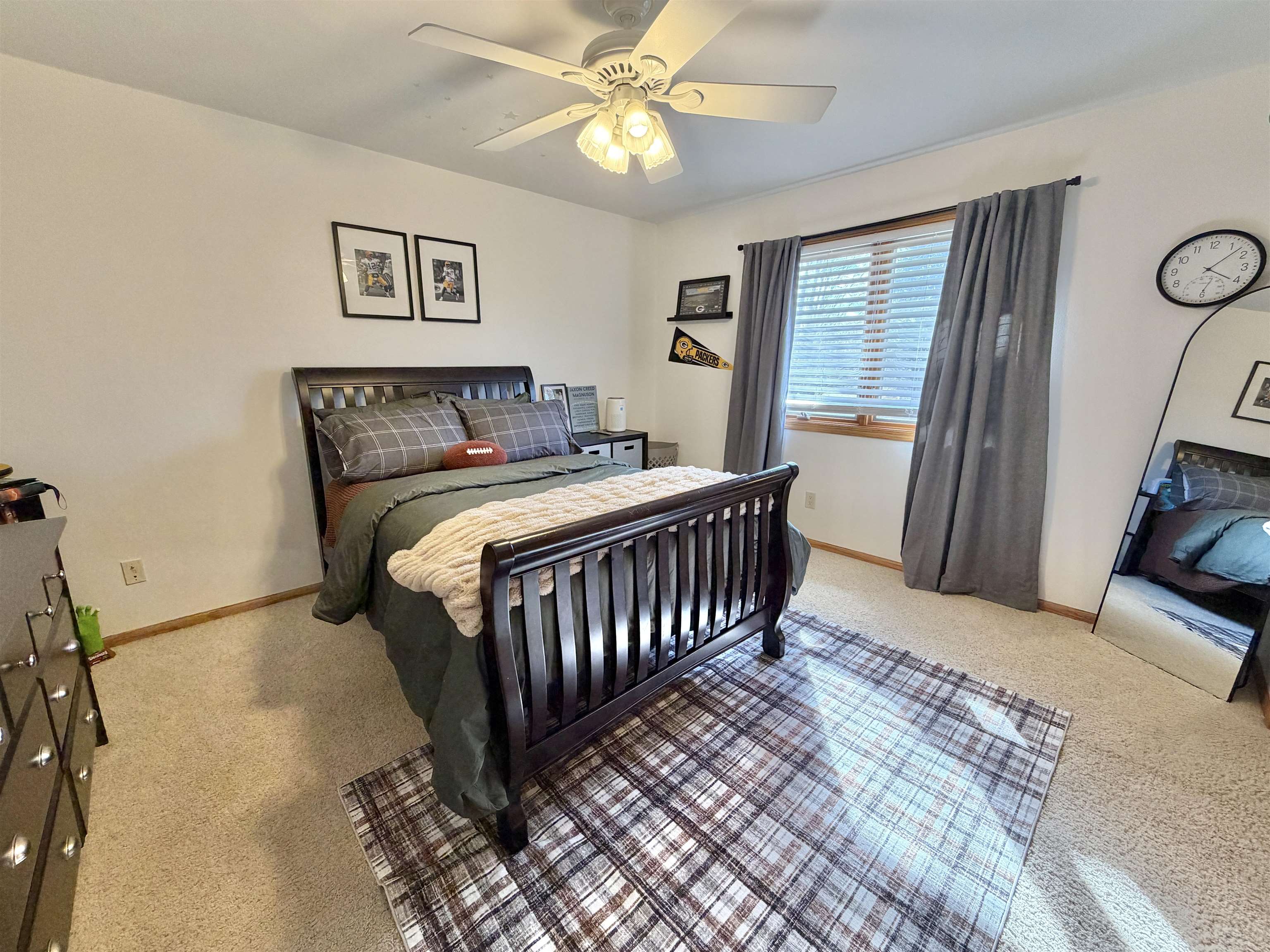 9102 River View Trail Roscoe, IL 61073 - Photo 25 of 40 a bedroom with a bed and a chandelier