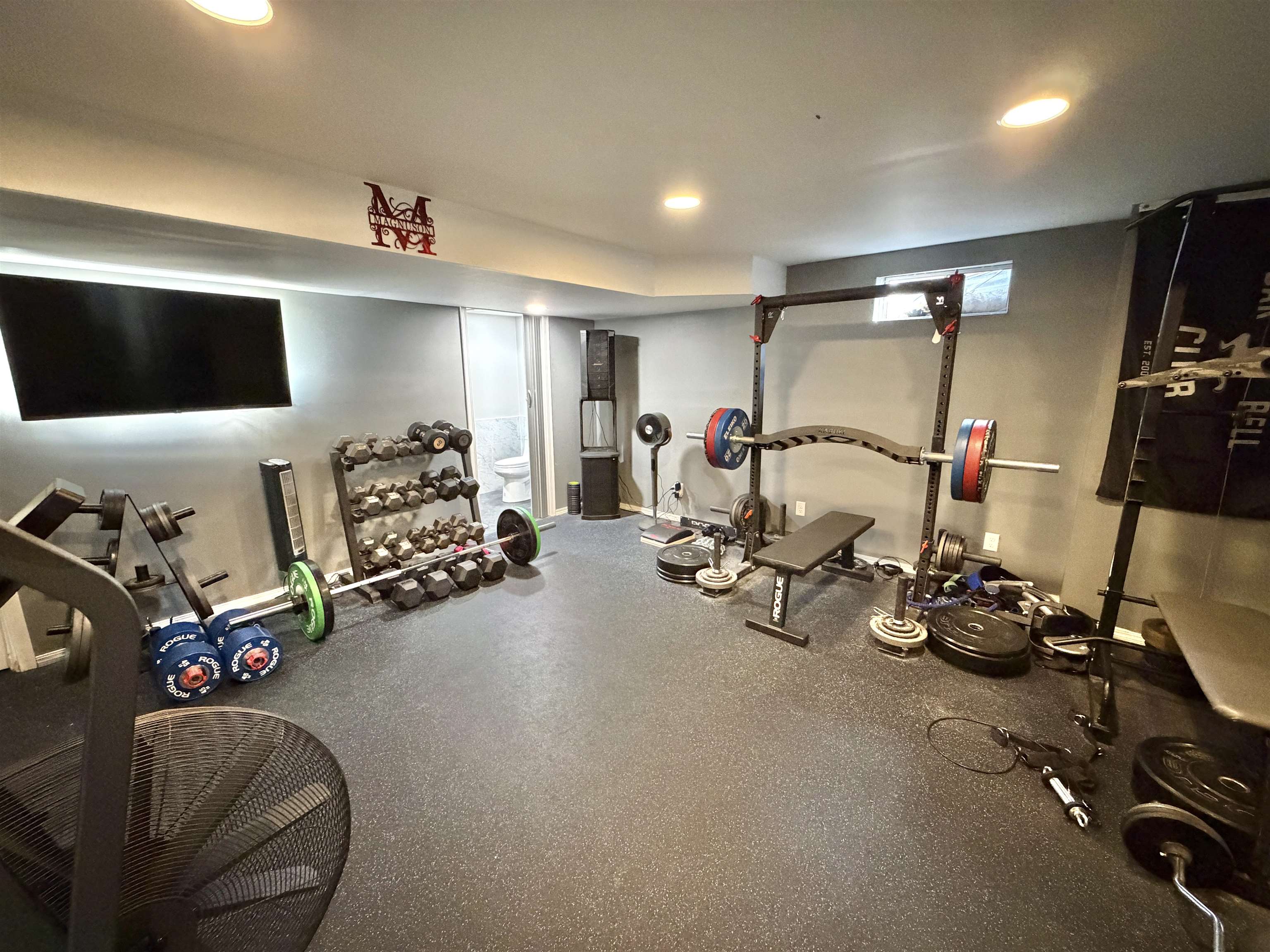 9102 River View Trail Roscoe, IL 61073 - Photo 33 of 40 a room with gym equipment and a flat screen tv