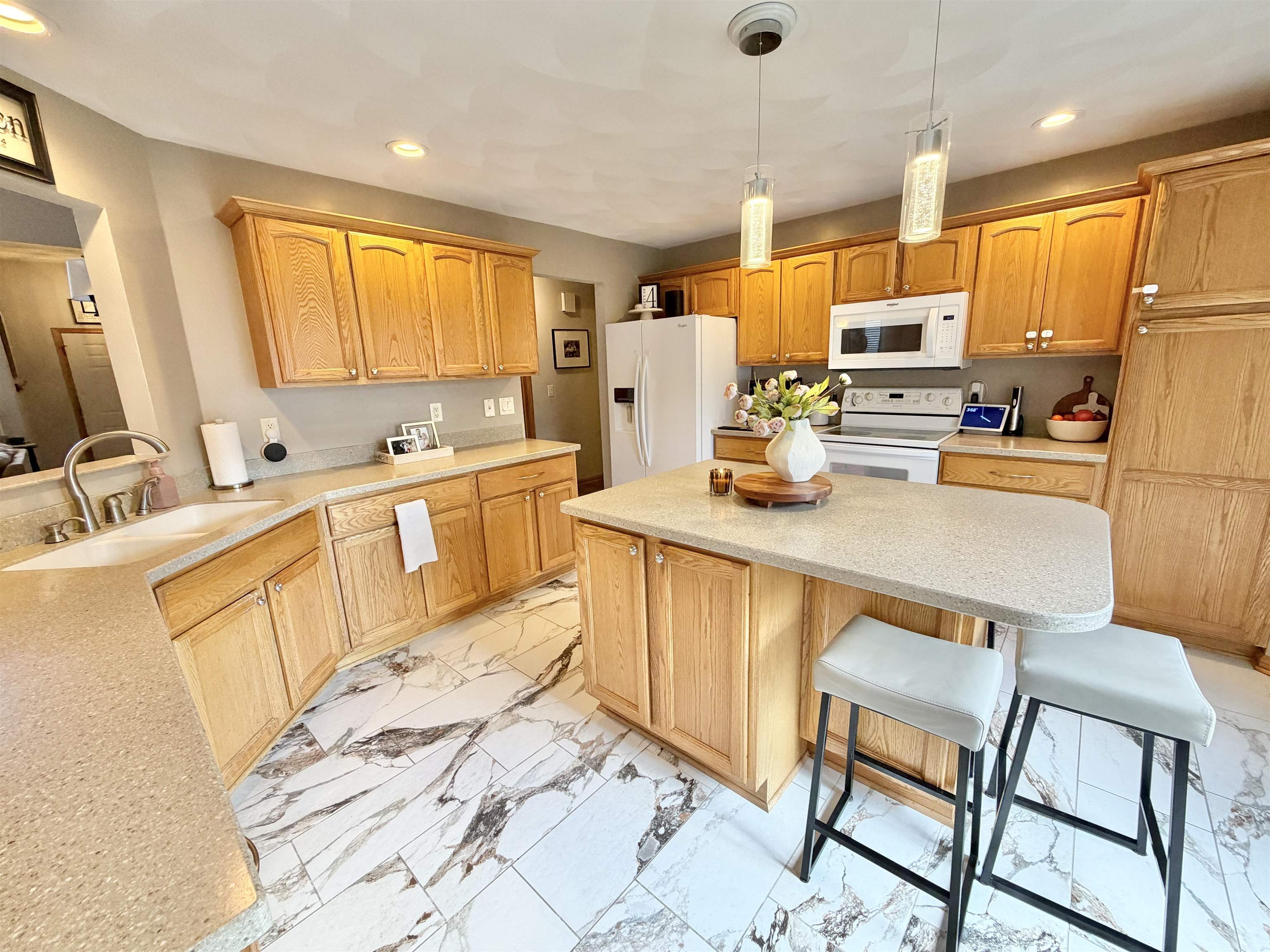 9102 River View Trail Roscoe, IL 61073 - Photo 10 of 40 a large kitchen with a table chairs microwave and cabinets