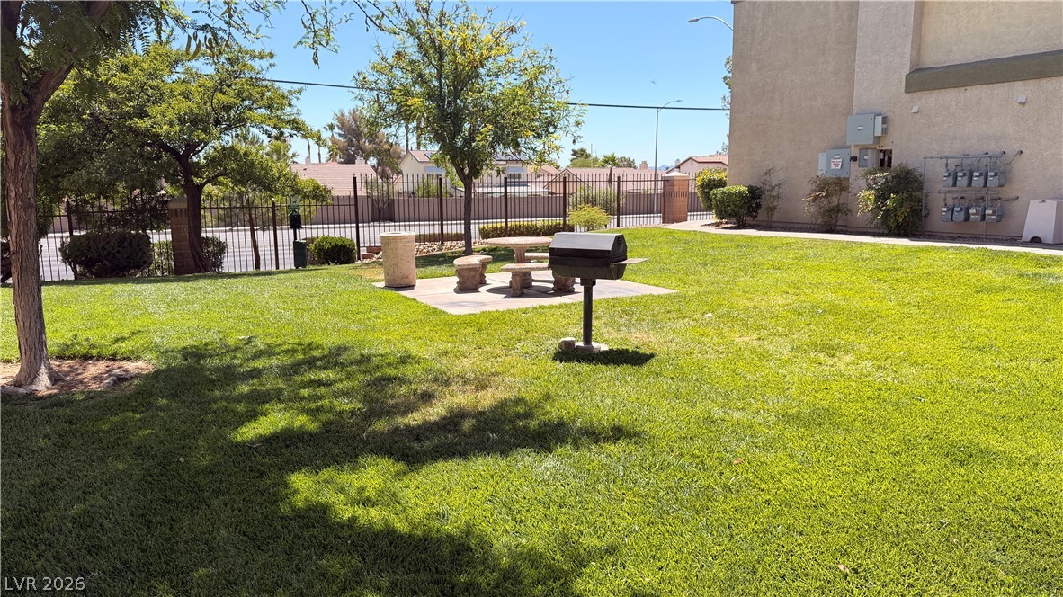 7885 West Flamingo Road, Unit 1131 Las Vegas, NV 89147 - Photo 34 of 36 A vibrant green lawn area provides ample space for outdoor enjoyment and grilling.