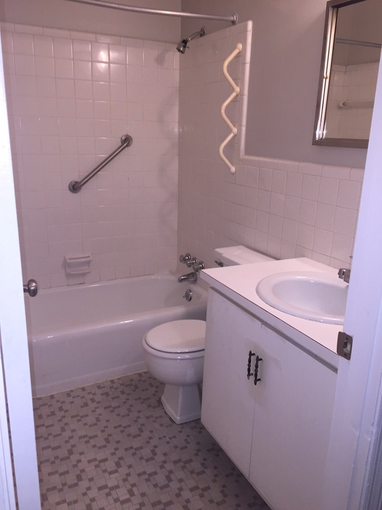 1550 Stark Avenue, Unit 5 Columbus, GA 31906 - Photo 5 of 7 a bathroom with a sink a toilet and shower