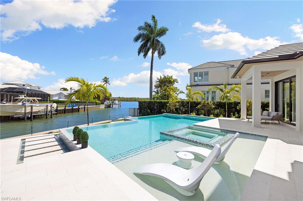2345 Tarpon Road Naples, FL 34102 - Photo 15 of 43 Integrated pool / spa featuring a patio, a water view, and a boat dock