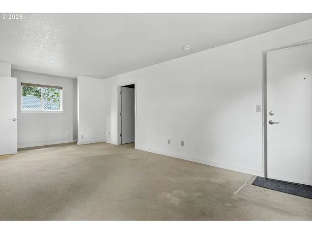 a view of an empty room with windows