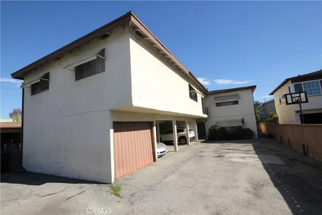 a view of house with backyard and a trees