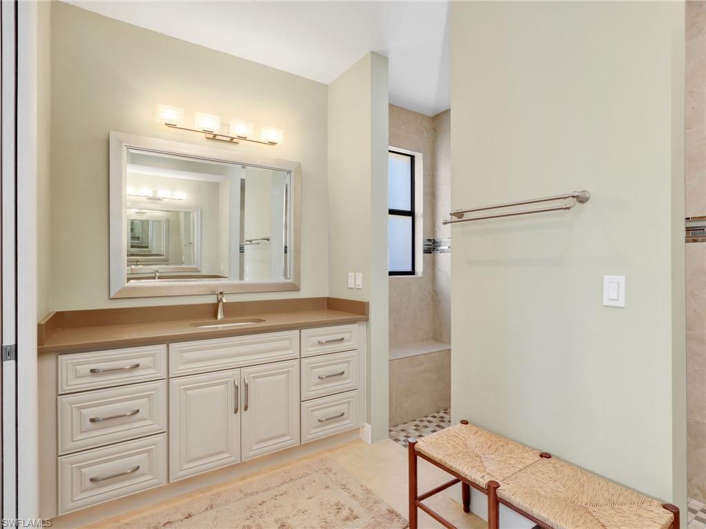 3160 27th Avenue Southwest Naples, FL 34117 - Photo 20 of 43 a spacious bathroom with a granite countertop sink a mirror and a