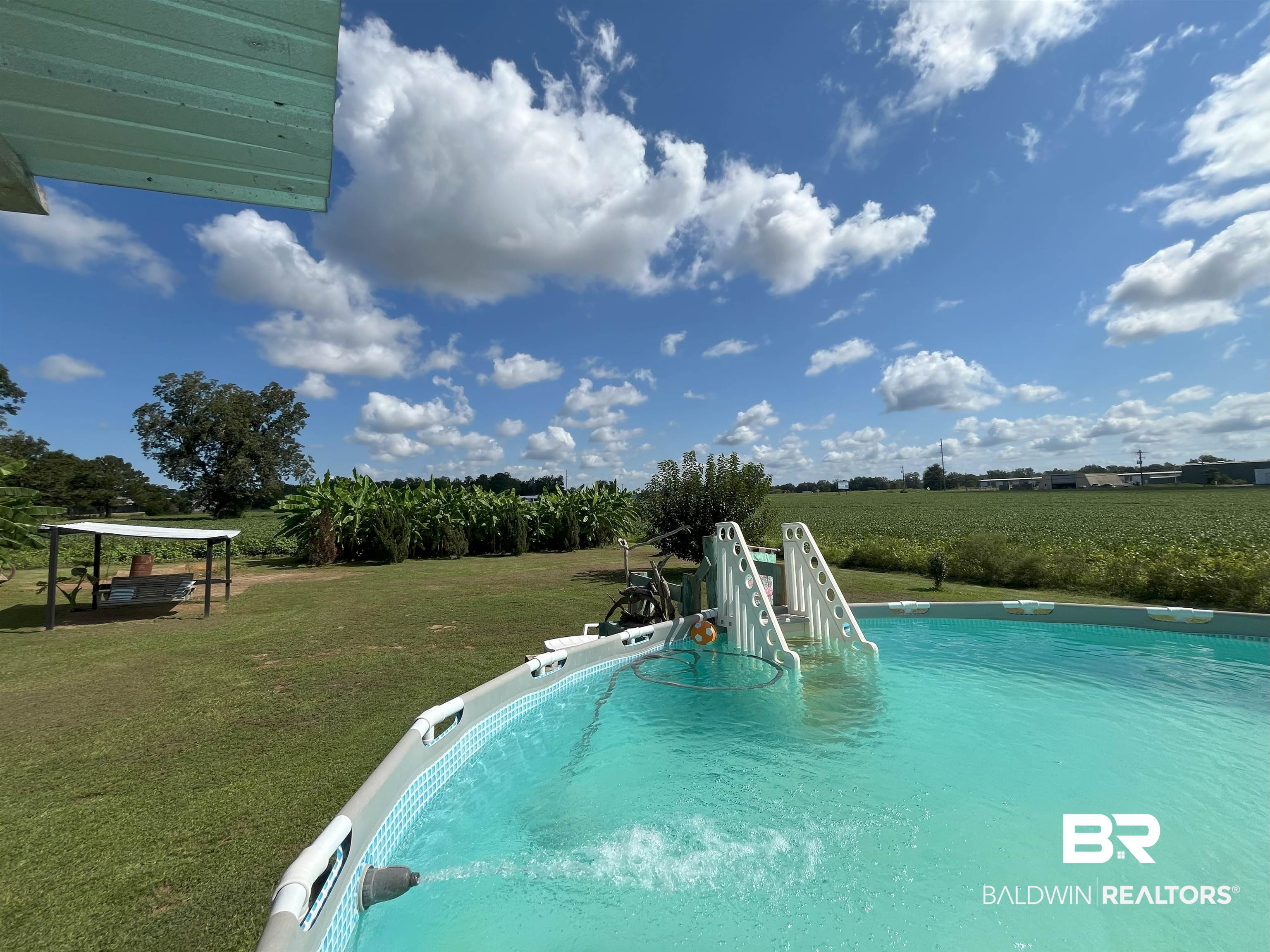 7851 Highway 98 Fairhope, AL 36532 - Photo 34 of 40 Swimming pool featuring a lawn, a view of rural / pastoral area, and agricultural plots