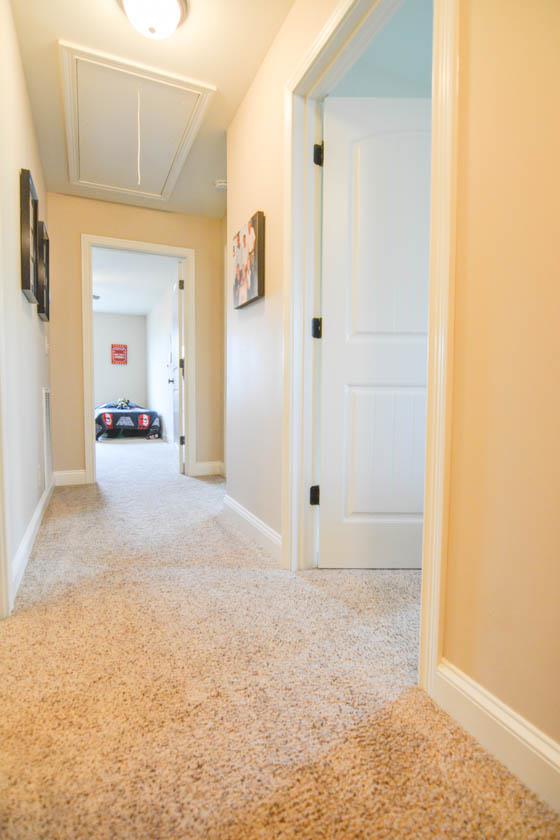 2590 Gunn Road Adams, TN 37010 - Photo 16 of 30 a view of a hallway with wooden floor and a bathroom