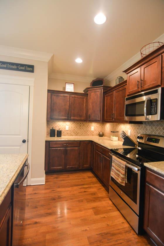2590 Gunn Road Adams, TN 37010 - Photo 8 of 30 a large kitchen with stainless steel appliances wooden cabinets and a stove top oven
