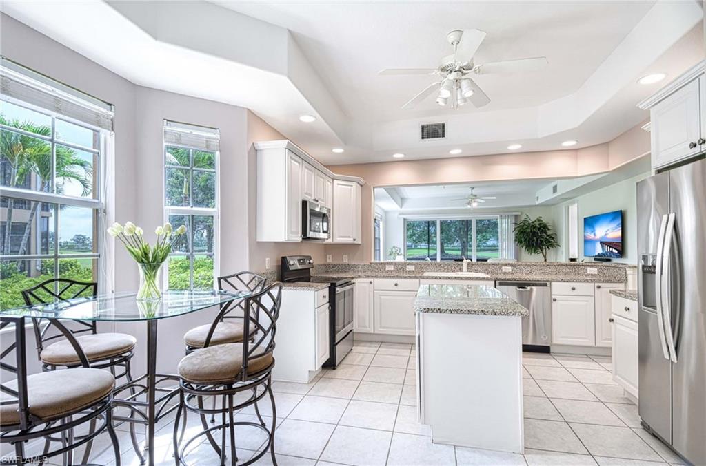 8649 Champions Point, Unit 1201 Naples, FL 34113 - Photo 7 of 23 Breakfast Nook and kitchen, center island, lighted ceiling fan, recessed lighting, more windows for natural light